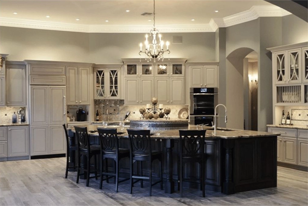 Elegant Tempe kitchen remodel featuring light gray cabinets, a large central island with dark wood base and five black chairs, chandelier lighting, built-in appliances, light wood floors, glass-front cabinets, and luxury kitchen accents.