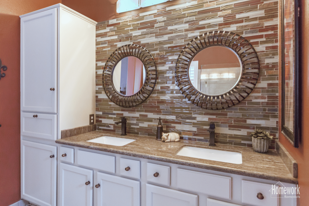 Cabinetry has been refreshed with white paint, brass hardware and tiled wall.
