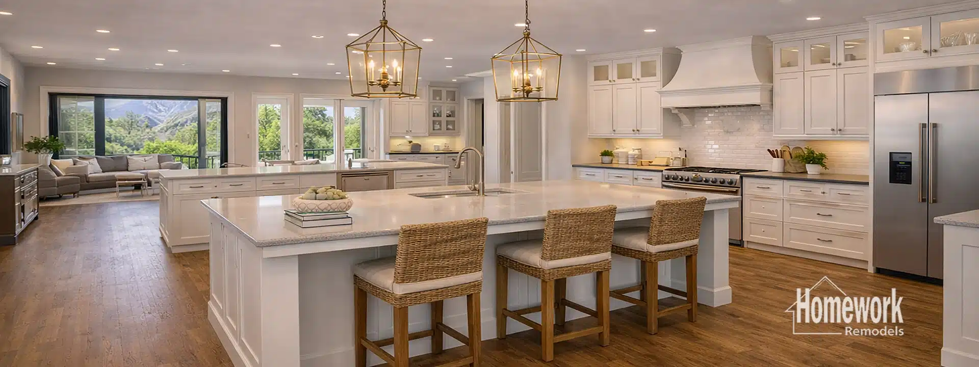 Spacious, modern kitchen in Arcadia with white cabinets, large island with sink, wicker barstools, stainless steel appliances, pendant lights, and hardwood floors—showcasing open concept remodeling with a bright living area and large windows in the background.