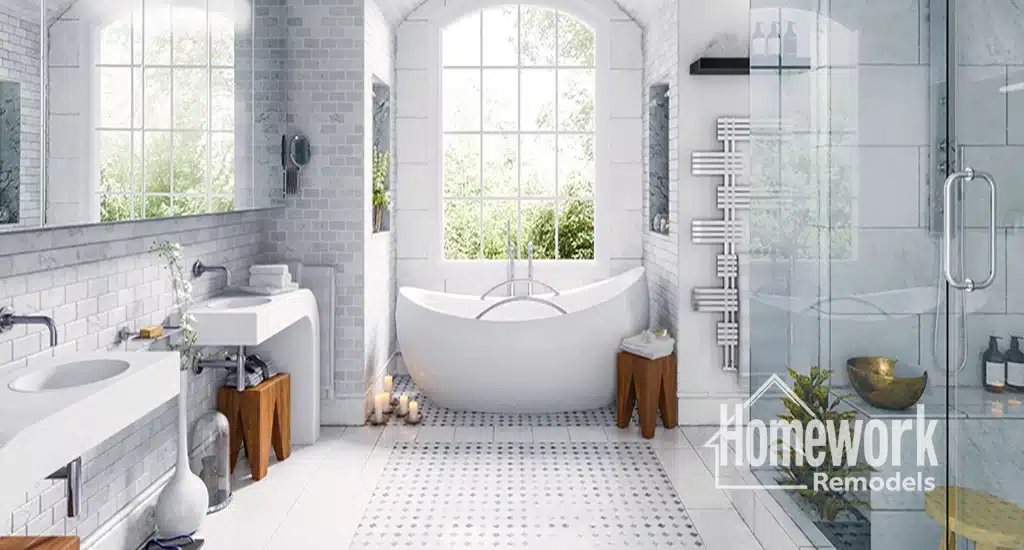North Glendale Homes: Bright, modern bathroom with a freestanding bathtub by large windows, double sinks, walk-in glass shower, white tiles, wood accents, green plants, and Homework Remodels logo in the lower right corner.