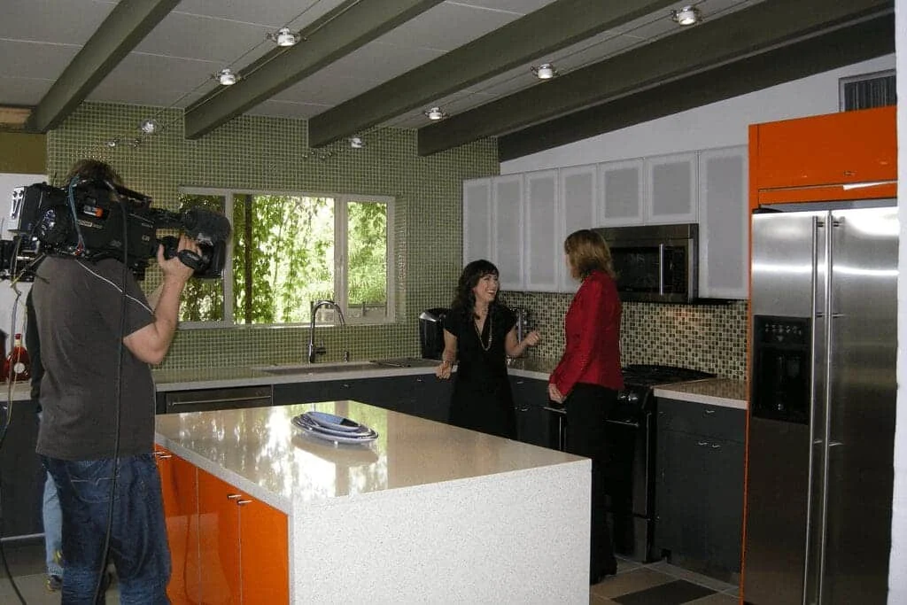 HGTV camera crew filming in the completed mid-century modern kitchen of a Ralph Haver home in Marlen Grove, Phoenix