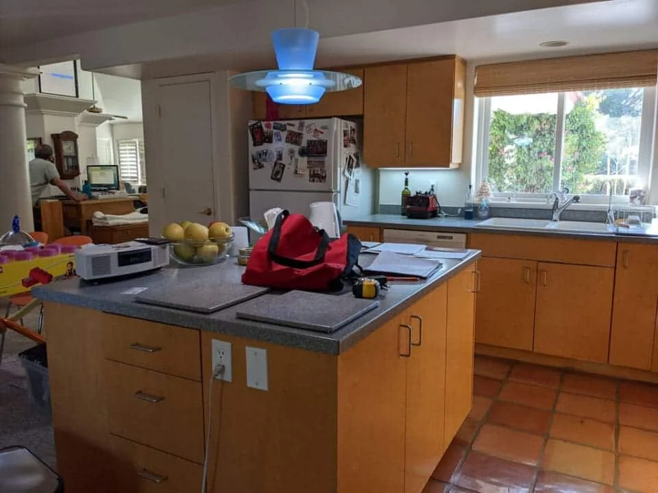 Original Mesa kitchen with wood cabinets, a gray island countertop, older refrigeration, and warm-toned tile flooring