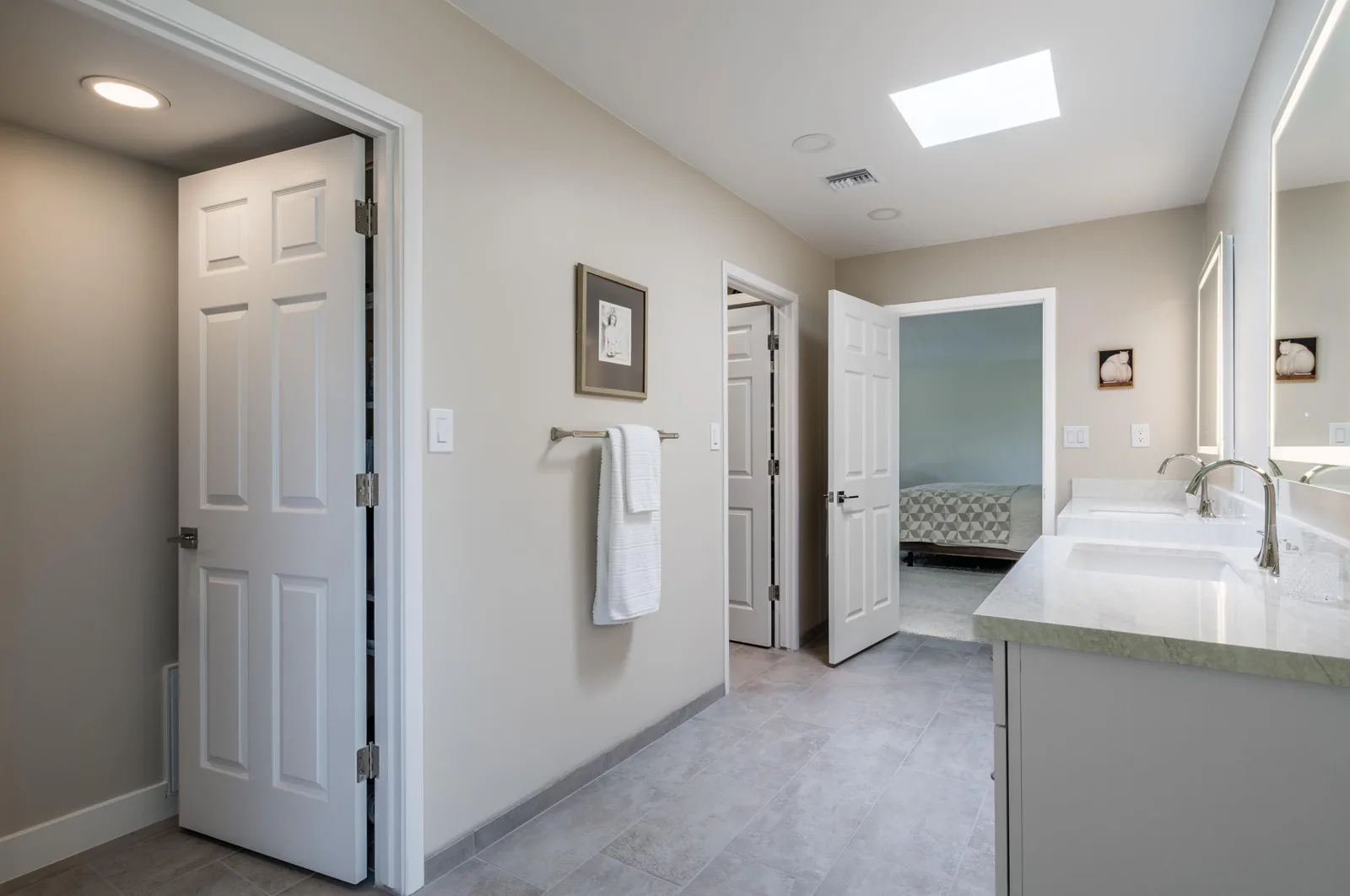 Paradise Valley primary bathroom remodel with custom vanity cabinetry, illuminated mirrors, wide doorways, and a curbless shower