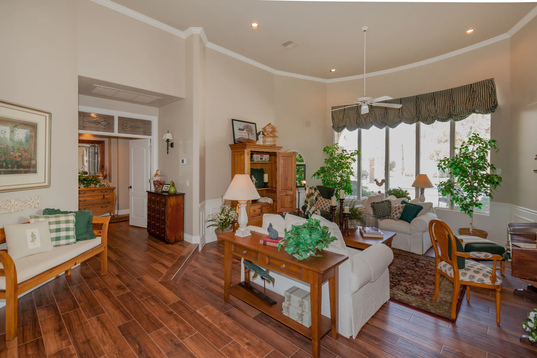 Completed Paradise Valley living room with wood-look porcelain tile, refreshed wall colors, and the homeowner’s existing furniture