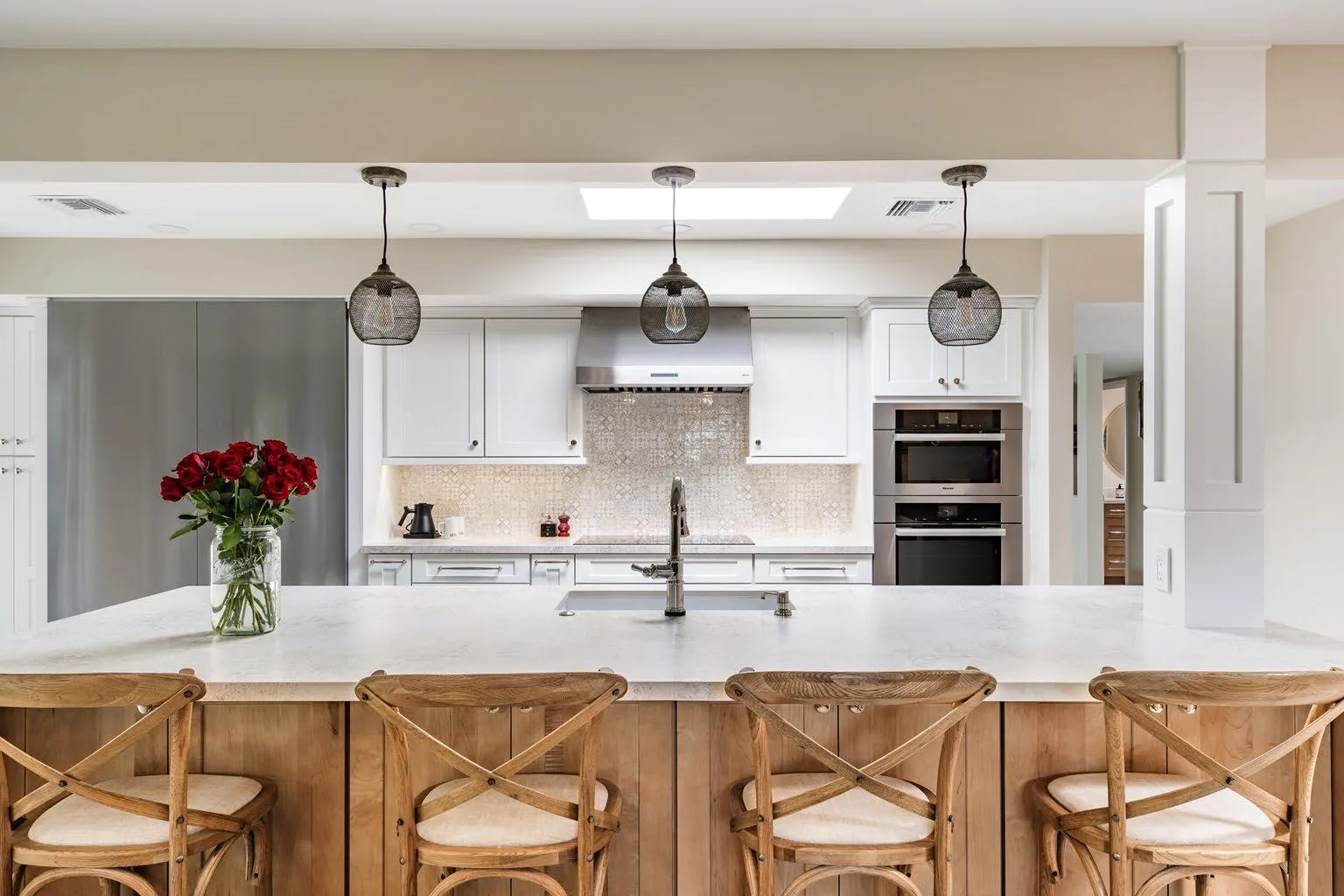 Paradise Valley whole-home interior remodel with a waterfall kitchen island, two-tone cabinetry, pendant lighting, and seating for five