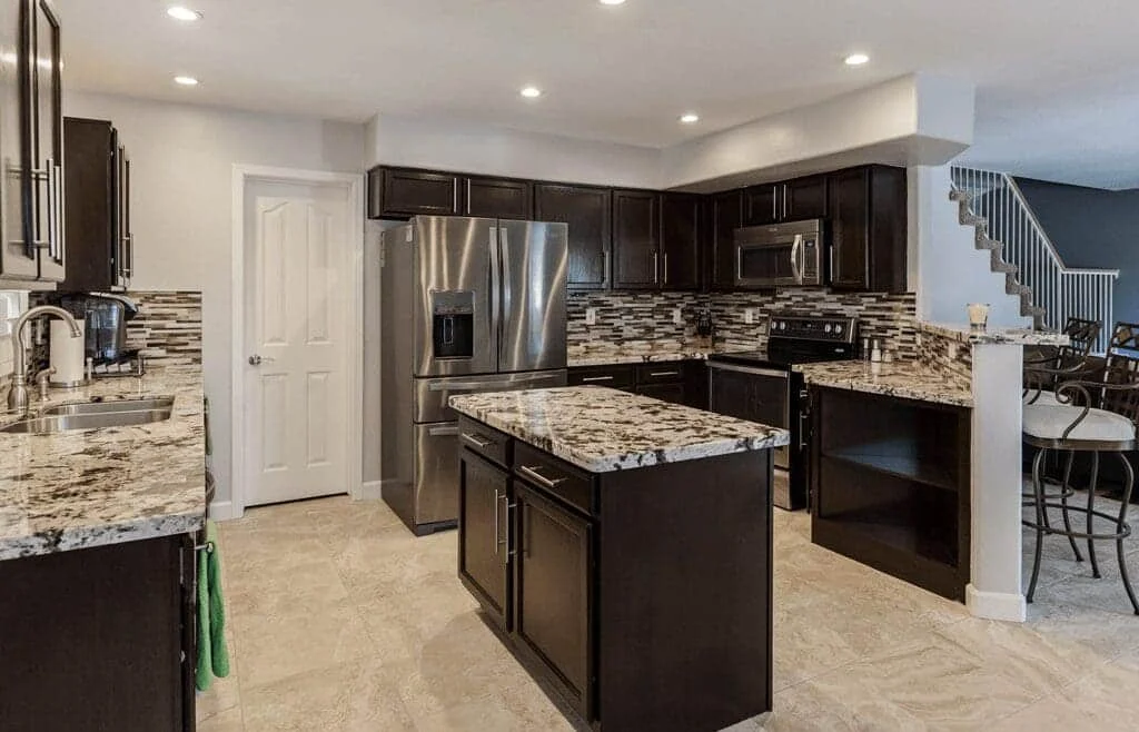 Phoenix kitchen remodel with espresso cabinets, Alaska granite countertops, and a central island