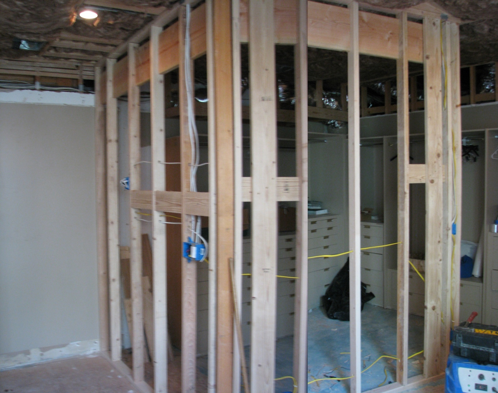 Exposed wall and ceiling framing during the historic bathroom and closet renovation