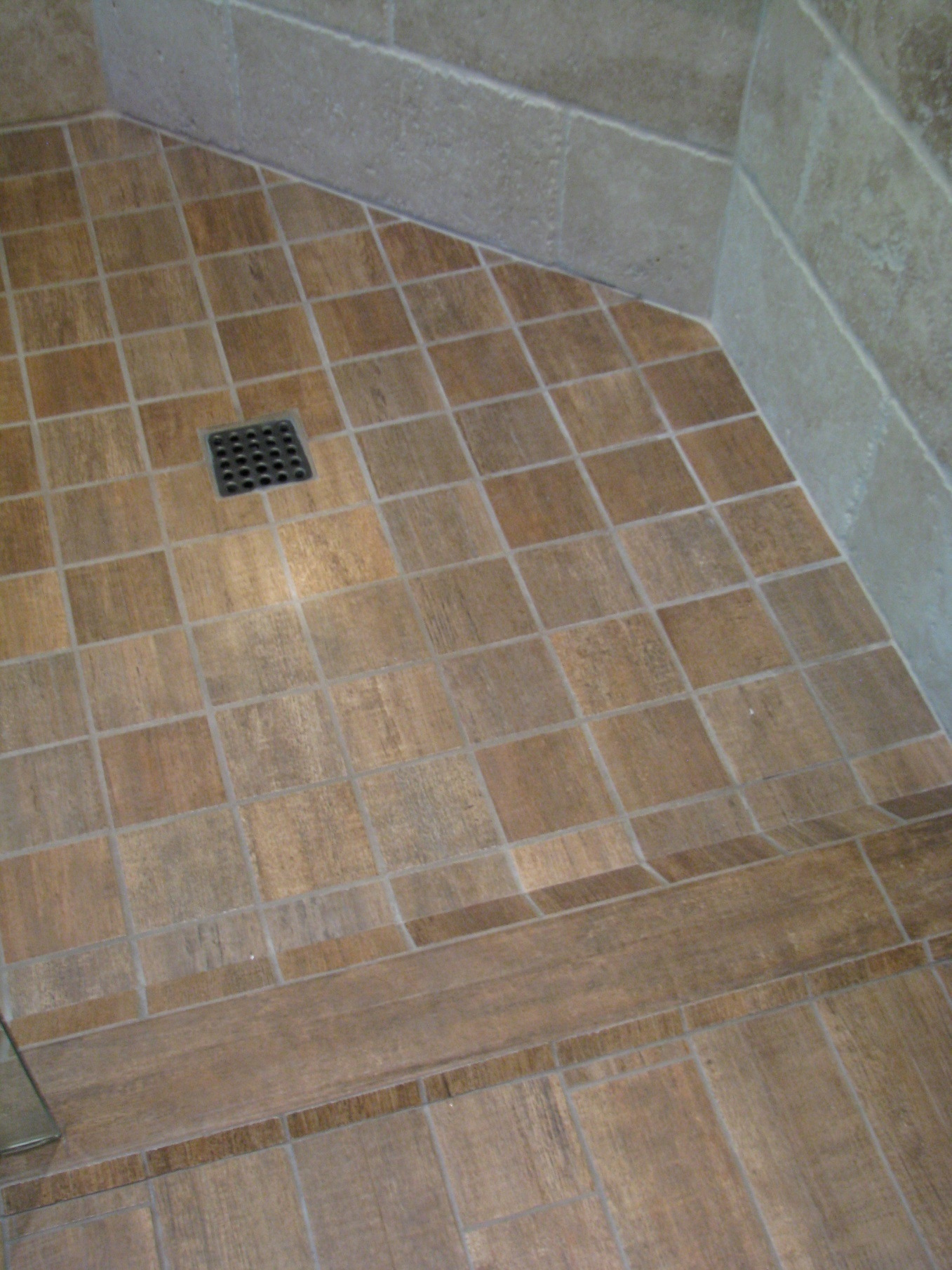 Recessed tiled shower floor and drain in the Willo primary bathroom