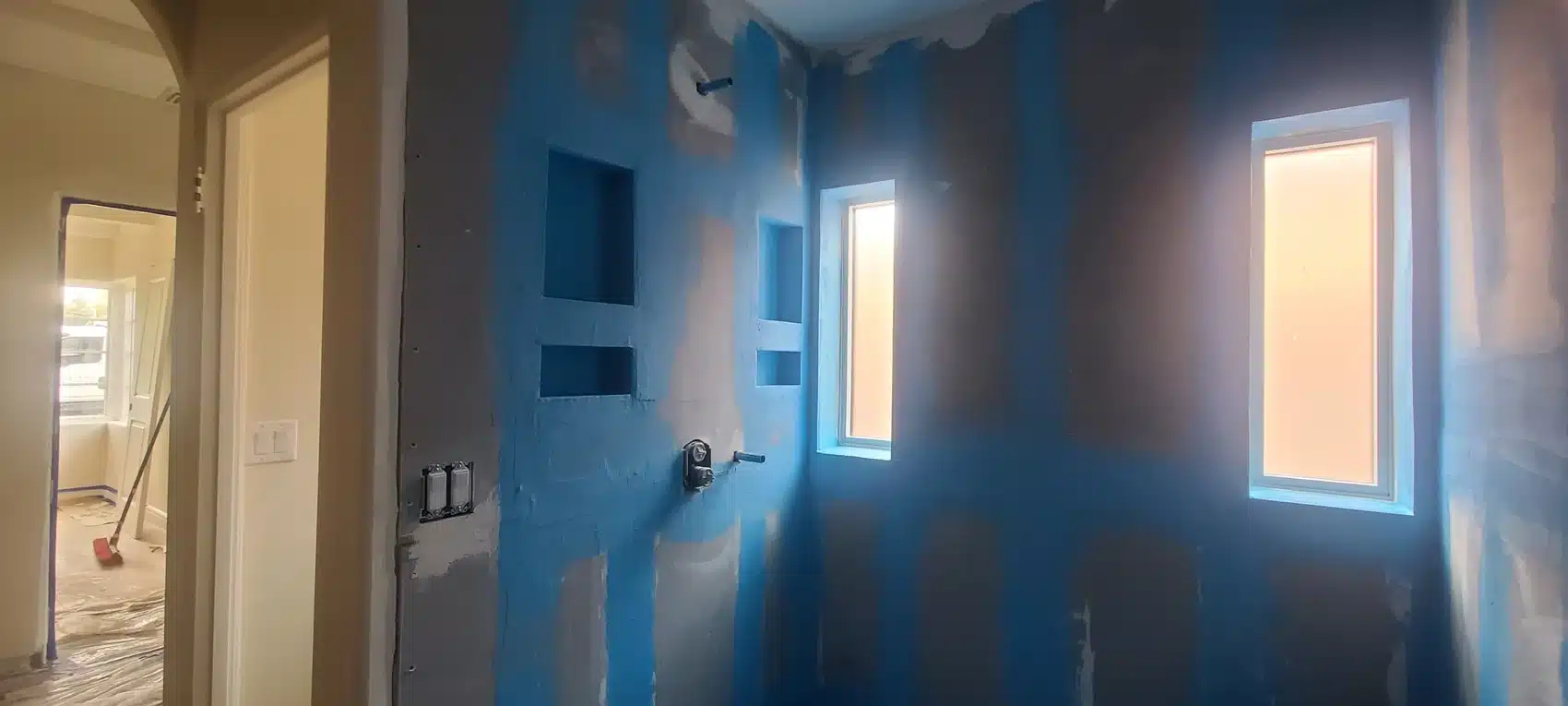 Blue waterproofing applied to shower walls and recessed shower floor
