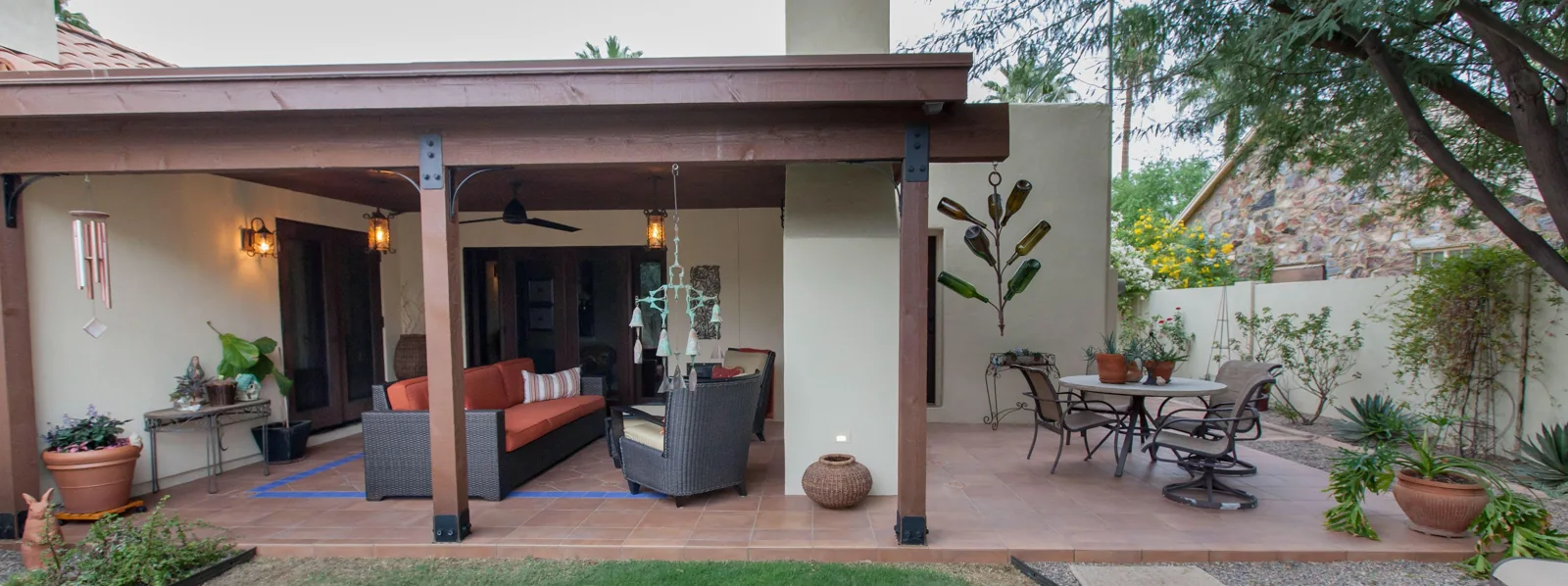First phase of the exterior remodel showing a roofed patio with seating and a fireplace