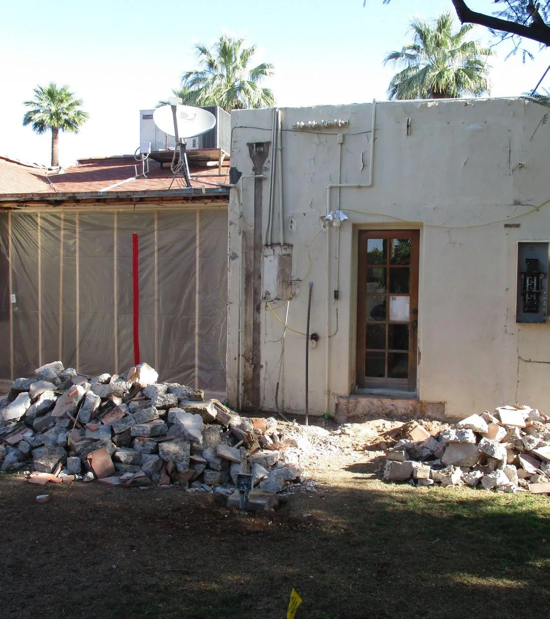 Back of the historic home during demolition with the original patio cover removed